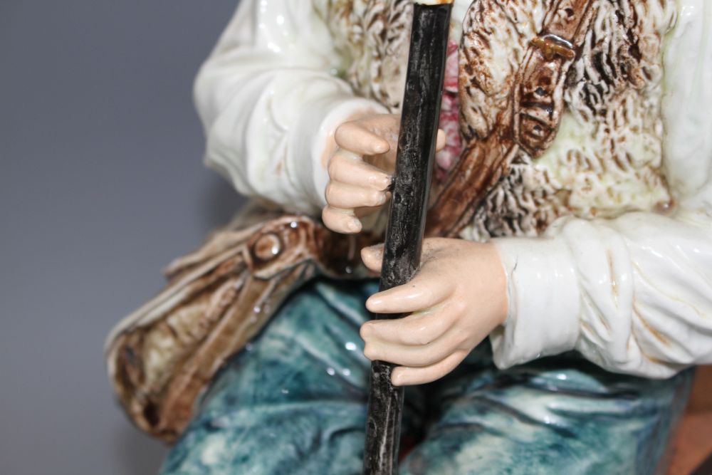 A late 19th century Austrian tin glaze pottery figure of a Tyrolean boy playing a flute, seated upon a bamboo wood chair, height 43cm